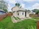 Charming tan two-story home with a small front yard and stone walkway to the front door at 704 E Perry St, Indianapolis, IN 46227