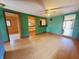 A view of the living room shows an open floor plan with hardwood floors and colorful green walls at 704 E Perry St, Indianapolis, IN 46227