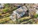 Aerial shot of a home with a large deck, swing, and stone landscaping in a wooded area at 7335 Bethany Park, Martinsville, IN 46151