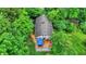 Aerial view of a house nestled among lush green trees, featuring a deck with a blue canopy at 7335 Bethany Park, Martinsville, IN 46151