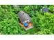 Aerial view of a house nestled among lush green trees, featuring a deck with a blue canopy at 7335 Bethany Park, Martinsville, IN 46151