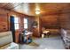Well-lit attic featuring wood paneled walls, two windows, and neutral carpeting at 7335 Bethany Park, Martinsville, IN 46151