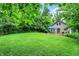 Spacious backyard featuring a large grassy lawn and a cozy deck with a blue canopy at 7335 Bethany Park, Martinsville, IN 46151