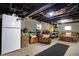 Finished basement includes concrete walls, a sofa and recliner and a white refrigerator at 7335 Bethany Park, Martinsville, IN 46151