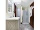 Bright bathroom featuring a modern vanity, walk-in shower, and wood-look flooring at 7335 Bethany Park, Martinsville, IN 46151