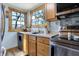 Stylish kitchen featuring stainless steel appliances, wood cabinets, and a patterned backsplash at 7335 Bethany Park, Martinsville, IN 46151