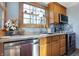Charming kitchen features stainless steel appliances, wood cabinets, and a bright window above the sink at 7335 Bethany Park, Martinsville, IN 46151