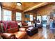 Spacious living room with hardwood floors, featuring a fireplace, comfy seating, and a view of laundry at 7335 Bethany Park, Martinsville, IN 46151