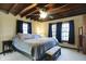 Relaxing bedroom featuring a king size bed, neutral decor and a wood-beamed ceiling at 7335 Bethany Park, Martinsville, IN 46151