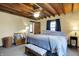 Comfortable bedroom featuring a king bed, wood beam ceiling, and plenty of natural light at 7335 Bethany Park, Martinsville, IN 46151