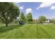 Expansive backyard features lush lawn, playground set, and basketball court, perfect for outdoor enjoyment at 7430 Franklin Parke Woods, Indianapolis, IN 46259
