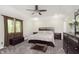 Spacious primary bedroom featuring tray ceiling, a ceiling fan, and a large bed with matching furniture at 7430 Franklin Parke Woods, Indianapolis, IN 46259