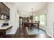 Charming dining area with a wooden table set, view to modern kitchen and adjacent workstation nook with granite countertop at 7430 Franklin Parke Woods, Indianapolis, IN 46259