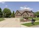 Stately brick home with attached garage and long driveway at 7430 Franklin Parke Woods, Indianapolis, IN 46259