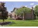 Beautiful brick home with a well-maintained lawn and mature trees at 7430 Franklin Parke Woods, Indianapolis, IN 46259