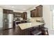 Well-equipped kitchen with stainless steel appliances, dark wood cabinets, granite countertops, and breakfast bar seating at 7430 Franklin Parke Woods, Indianapolis, IN 46259