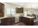 Bright kitchen featuring granite countertops, dark cabinetry, stainless steel appliances, and an open layout to dining at 7430 Franklin Parke Woods, Indianapolis, IN 46259