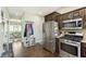 Efficient kitchen and hall layout with stainless steel appliances and convenient access to an adjacent dining area at 7430 Franklin Parke Woods, Indianapolis, IN 46259