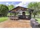 Outdoor living area with bar, grill, fireplace, and stamped concrete patio at 7430 Franklin Parke Woods, Indianapolis, IN 46259