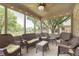 Enclosed patio with wicker furniture and string lights, overlooking backyard at 7430 Franklin Parke Woods, Indianapolis, IN 46259