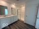 Modern bathroom with double sink vanity, large mirror, and glass-enclosed shower at 7517 Big Bend Blvd, Camby, IN 46113