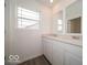 Elegant bathroom featuring double sinks, stone countertop, and a large window at 7517 Big Bend Blvd, Camby, IN 46113