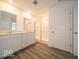 Bathroom features a double sink vanity, granite countertop, and glass shower door at 7517 Big Bend Blvd, Camby, IN 46113