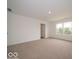 Well lit bedroom with neutral carpet and white walls and a door to a closet at 7517 Big Bend Blvd, Camby, IN 46113