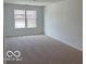 Inviting bedroom with plush carpet and a large window offering ample natural light at 7517 Big Bend Blvd, Camby, IN 46113