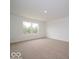 Bright bedroom features a large window, neutral carpet, and fresh white walls at 7517 Big Bend Blvd, Camby, IN 46113