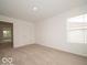 Well lit carpeted bedroom shows doorways and large window for natural light at 7517 Big Bend Blvd, Camby, IN 46113