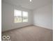 Bright bedroom with a large window offering natural light and neutral carpet at 7517 Big Bend Blvd, Camby, IN 46113