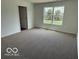 Cozy bedroom featuring plush carpet and a large window, offering a serene and inviting space at 7517 Big Bend Blvd, Camby, IN 46113