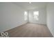Carpeted bedroom features white walls and two large windows for plenty of light at 7517 Big Bend Blvd, Camby, IN 46113