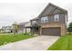 Two-story home with gray siding, stone accents, covered porch, and two-car garage at 7517 Big Bend Blvd, Camby, IN 46113