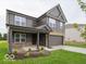 Two-story home with gray siding, stone accents, covered porch, and two-car garage at 7517 Big Bend Blvd, Camby, IN 46113