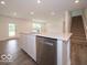 Beautiful kitchen island with stainless steel dishwasher, sink, and view of the back door and stairs at 7517 Big Bend Blvd, Camby, IN 46113