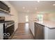 Modern kitchen with stainless steel appliances, white cabinets, and an island sink at 7517 Big Bend Blvd, Camby, IN 46113