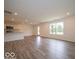 Open concept living room and kitchen with modern cabinets and stainless steel appliances at 7517 Big Bend Blvd, Camby, IN 46113