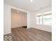 Living room with wood-look flooring and bright white walls and trim at 7517 Big Bend Blvd, Camby, IN 46113