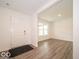 Living room with wood-look flooring and bright white walls and trim at 7517 Big Bend Blvd, Camby, IN 46113