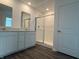 Bathroom with double sink vanity, large mirrors, and glass shower doors at 7605 Big Bend Blvd, Camby, IN 46113
