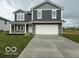 Two-story home featuring gray siding, white trim, and a two-car garage in a well manicured yard at 7605 Big Bend Blvd, Camby, IN 46113