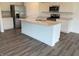 Modern kitchen with stainless steel appliances, an island with sink, white cabinets, and granite countertops at 7605 Big Bend Blvd, Camby, IN 46113
