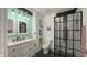 Modern bathroom featuring a white vanity, an exposed bulb light fixture, and a black-trimmed glass shower at 80 E College Ave, Martinsville, IN 46151