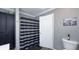This bathroom features a patterned shower curtain, dark wood accents, and neutral paint at 80 E College Ave, Martinsville, IN 46151