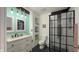 A stylish bathroom featuring double sinks, chic lighting, and a sleek, modern shower at 80 E College Ave, Martinsville, IN 46151