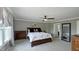 This bedroom features a large bed, plush carpeting, and neutral paint with lots of natural light at 80 E College Ave, Martinsville, IN 46151