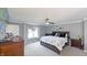 Bright primary bedroom with a ceiling fan, light gray walls, and a large window at 80 E College Ave, Martinsville, IN 46151