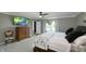 Comfortable bedroom features neutral paint, a fan, a TV, a large window, and soft carpeting at 80 E College Ave, Martinsville, IN 46151